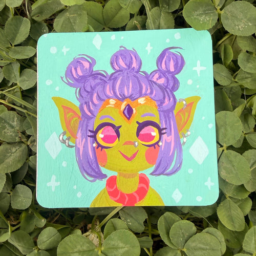 A square painting featuring a colorful cartoon goblin character with purple hair and greenish yellow skin, resting on a bed of green clover leaves.